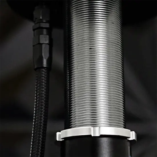 Threaded body air strut with braided airline